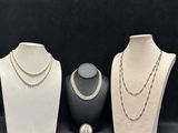 three different types of necklaces on display on a black background
