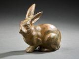 bronze sculpture of a rabbit on a gray surface