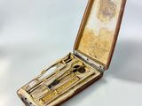 an old wooden case with a pair of scissors and a pair of scissors in it