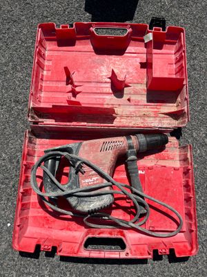 a red box with a drill and a cord in it