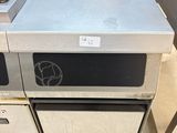 a silver oven sitting on top of a counter in a kitchen
