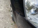 a close up of a car ' s headlight on the side of the road