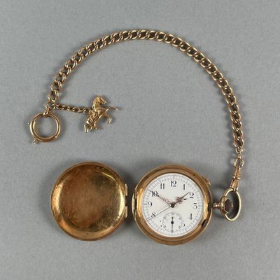 a gold pocket watch with a chain around it