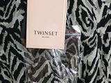 zebra print fabric with a tag that says twin set on it