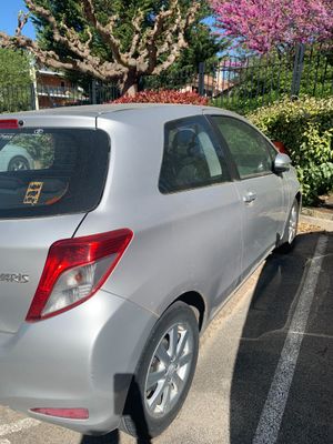 the rear end of a silver car parked in a parking lot