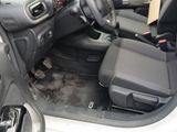 the interior of a car with the door open and the driver ' s seat down
