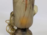a glass cup with a handle on a white surface