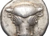 a close up of a silver coin with a bull head on it