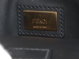 a close up of a black bag with a gold plate on it