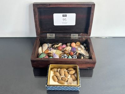 a wooden box filled with assorted items sitting on a table