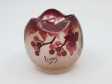 a small glass vase with a red flower on it