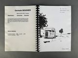 an open notebook with a drawing of a camper on it