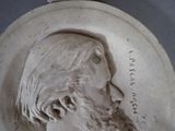 a close up of a plaque of a man with a beard
