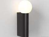 a black wall light with a white ball on top of it