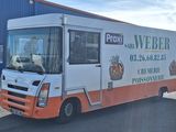 un camion de livraison garé devant un immeuble