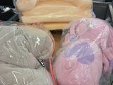several stuffed animals are wrapped in plastic in a shopping cart