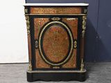an antique black and gold painted cabinet with a marble top