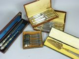 four different types of silverware in a wooden case