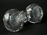 two clear glass knobs on a black surface with a black background