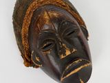 an old wooden mask on a white background with a white background