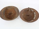 two brown bowls sitting next to each other on a white surface