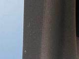 a close up of a piece of black fabric hanging on a clothes rack