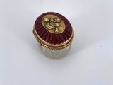 a close up of a red and gold box on a white surface