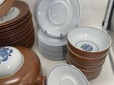 many plates and cups and saucers on the table