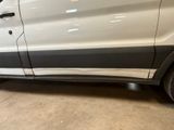 a white van parked in a garage with its door open