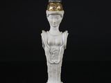 a white figurine of a woman with a crown on her head
