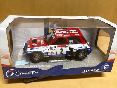 a red and white car in a box on a table