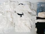 a lot of clothes that are sitting on a table