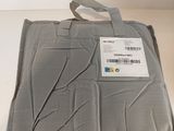 a gray blanket on a white table with a tag on it
