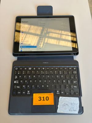 a laptop computer sitting on a table with a price tag on it