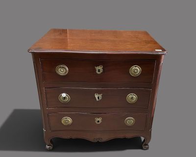 an antique chest of drawers on casteors with brass handles
