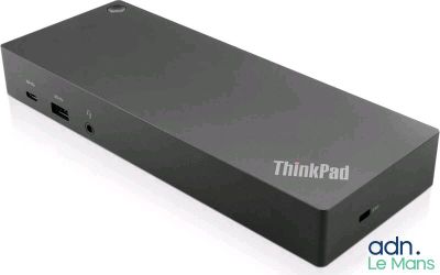 un gros plan d'un petit appareil noir posé sur une surface blanche