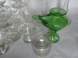 many glass vases and glasses sitting on a table
