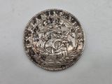 a close up of a silver coin with a ship on it