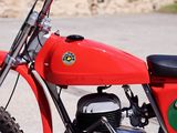 a red and green motorcycle parked in a parking lot