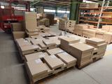 boxes are stacked on pallets in a large warehouse area