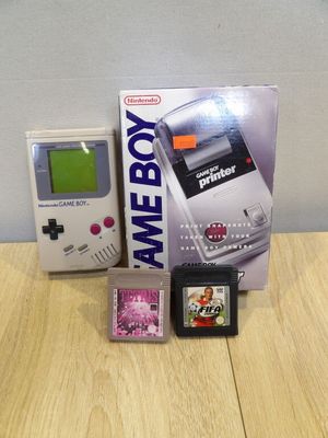 a nintendo game boy next to a nintendo game console