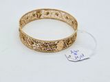 a close up of a gold bracelet with a tag on it