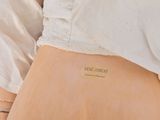 a picture of a woman ' s stomach with a tattoo on it