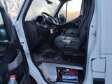 a white van that has the door open and the driver ' s seat down