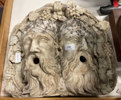a stone sculpture of a man and a woman on display