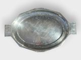 a silver tray with a handle on a white surface