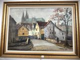 une peinture accrochée au mur d'un immeuble, avec une église en arrière-plan