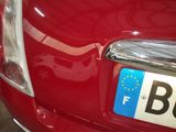 a close up of a car ' s license plate on the front of a car