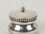 a silver plated box with a beaded lid on a white background