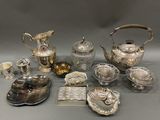 a lot of silver items that are sitting on a table